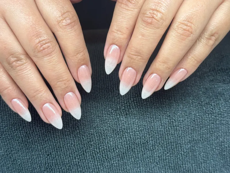 Baby-boomer ombré almond nails fading from sheer pink to white